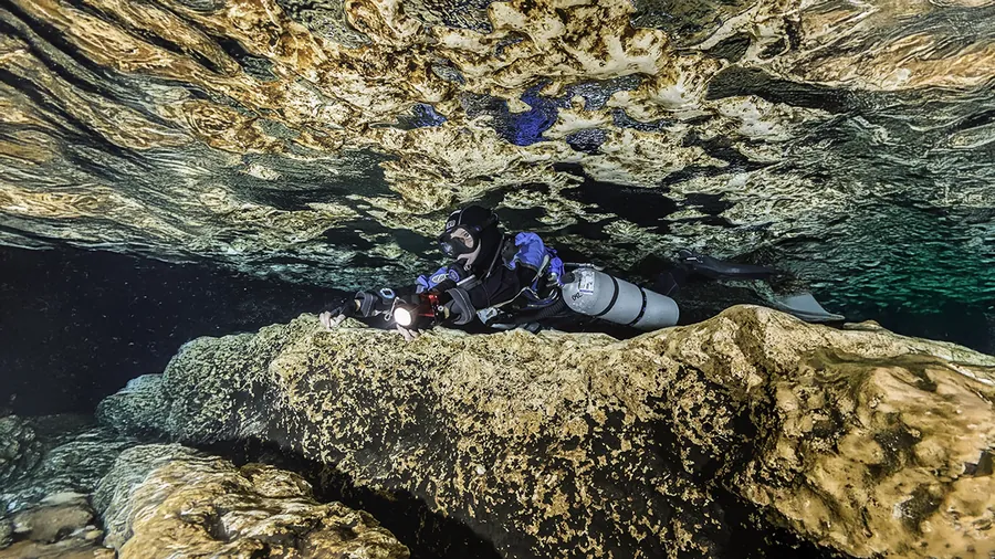 Diver in sidemount configuration inside a cave