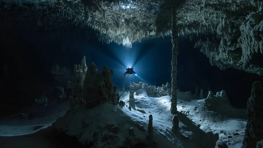Diver lighting up a flooded mine gallery